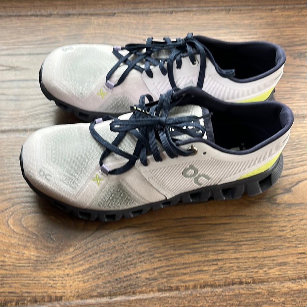 On Running White and Blue Athletic Shoes Streamlined Design
